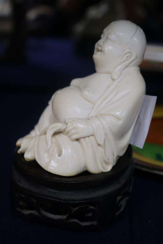 A Chinese ivory figure of Budai wood stand